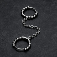 Hopeiset Double Huggie Ball Hoops ketjuyhteydellä tummalla taustalla
