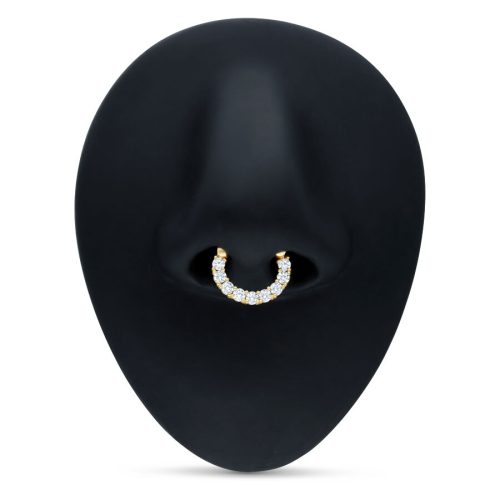 Kultainen septum clicker kirkkailla kristalleilla mustalla taustalla
