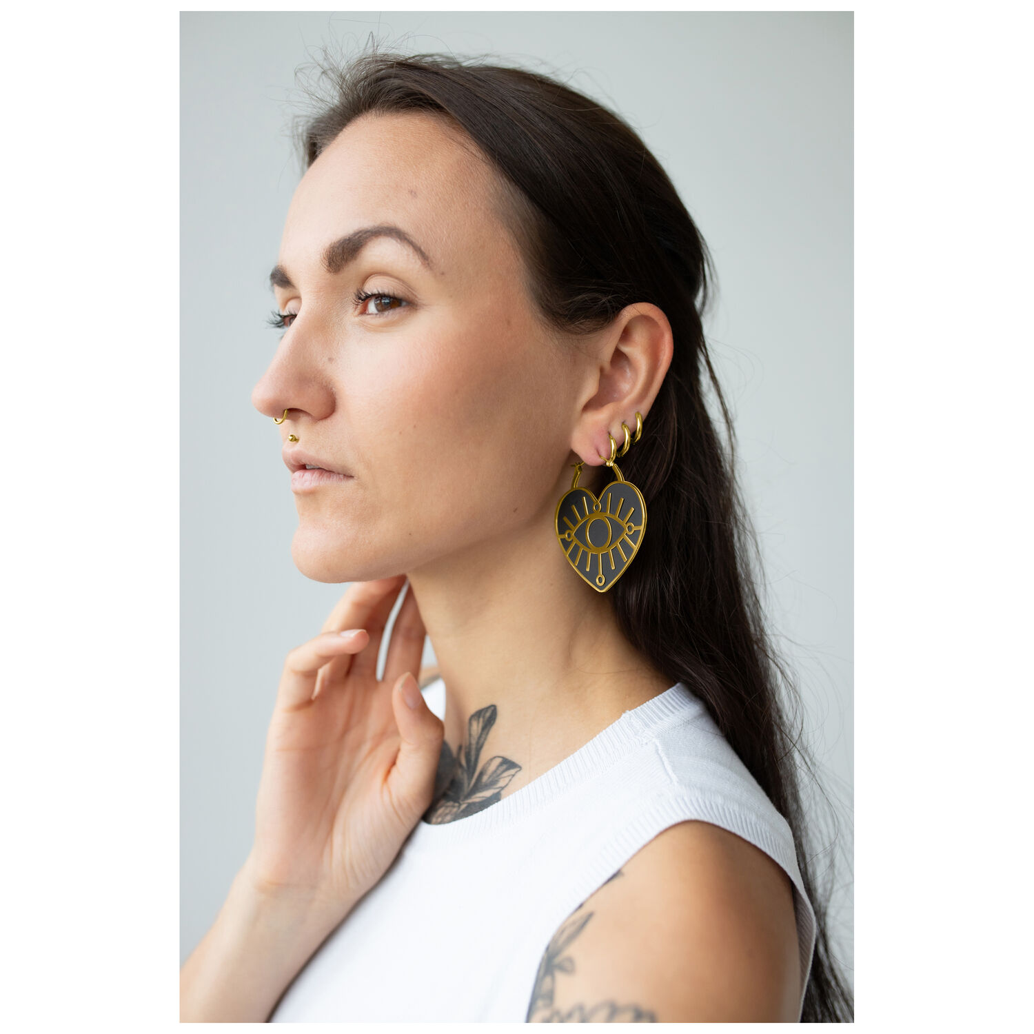 Pitkähiuksinen nainen käyttää kultaisia Soulmate Hoops -korvakoruja klipsikiinnityksellä.