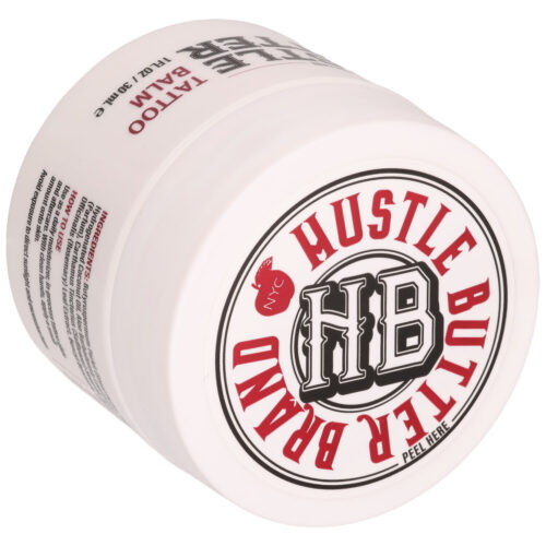Valkoinen purkki Hustle Butter -brändillä ja punaisella tekstillä, sivuttain