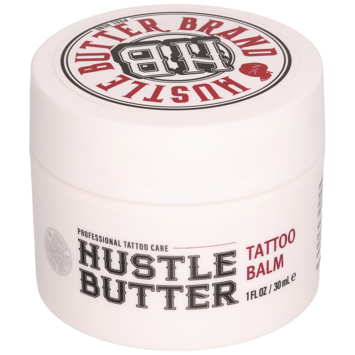 Valkoinen purkki Hustle Butter Tattoo Balsamia, jossa on punainen ja musta teksti valkoisella taustalla